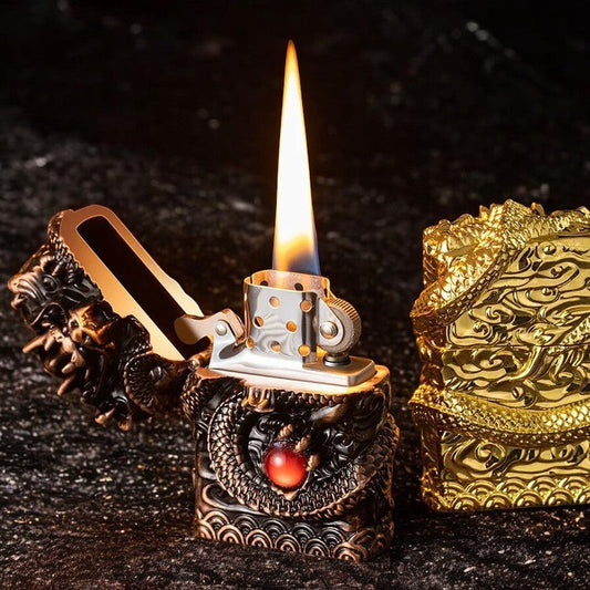 A Dragon Orb Lighter with a flame, featuring a 3D design of a coiled dragon around a red orb, with options for black and gold or full gold finishes.