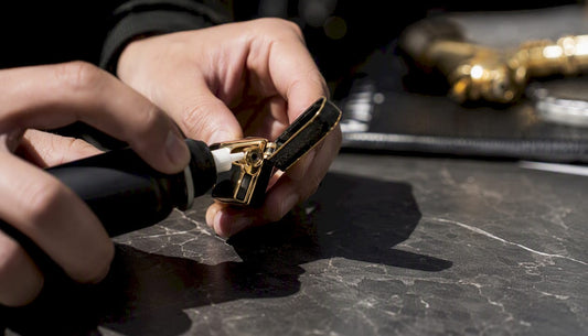 Hands refilling torch lighter with butane gas