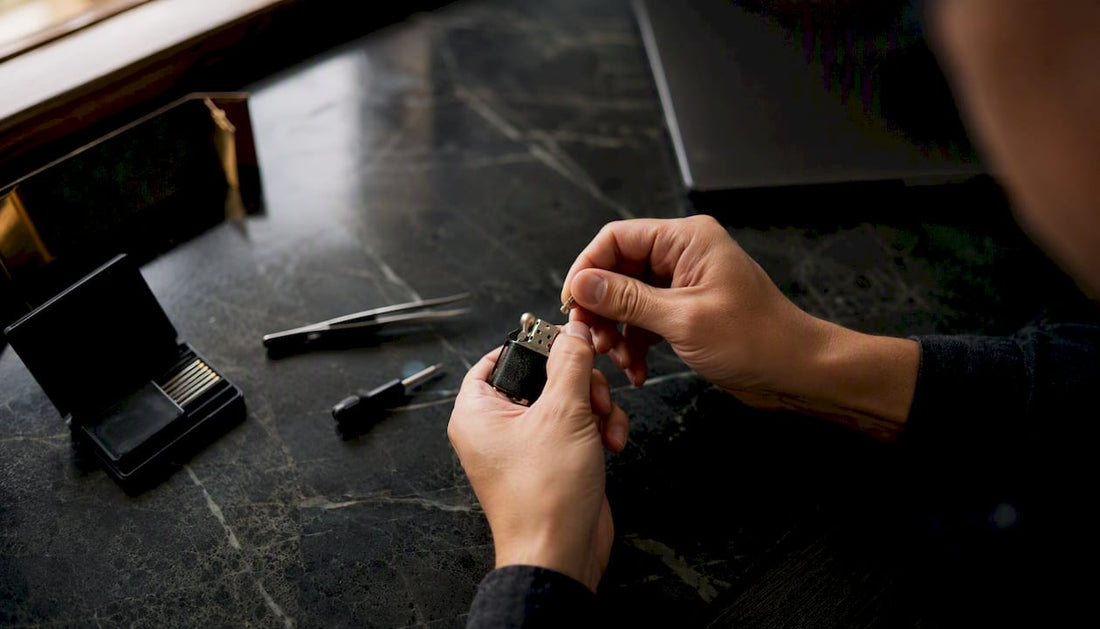 Hands replacing lighter flint with tools