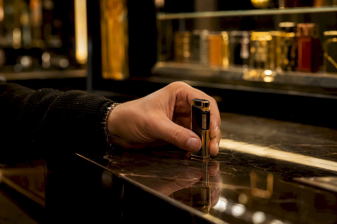 Adult holding collectible lighter at counter