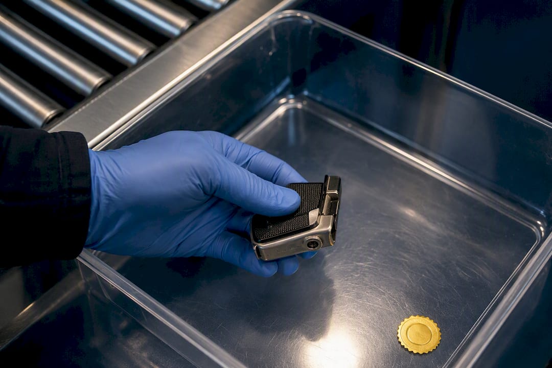 Partial gun-shaped lighter in security tray