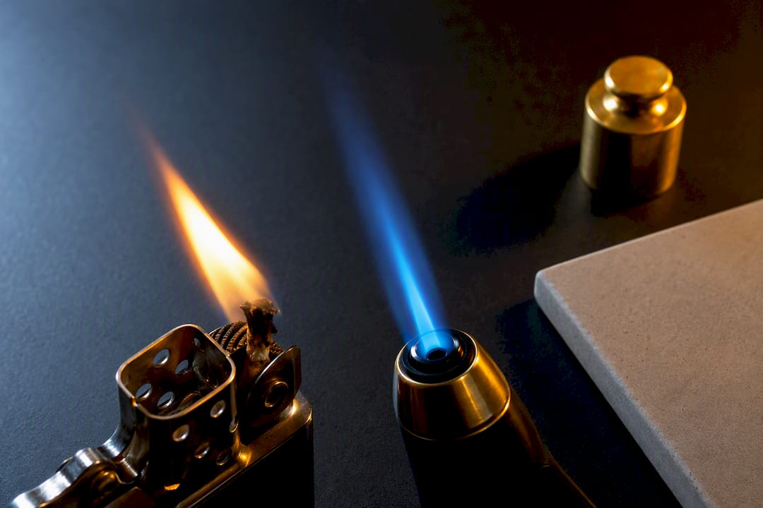 Wick flame beside blue torch flame