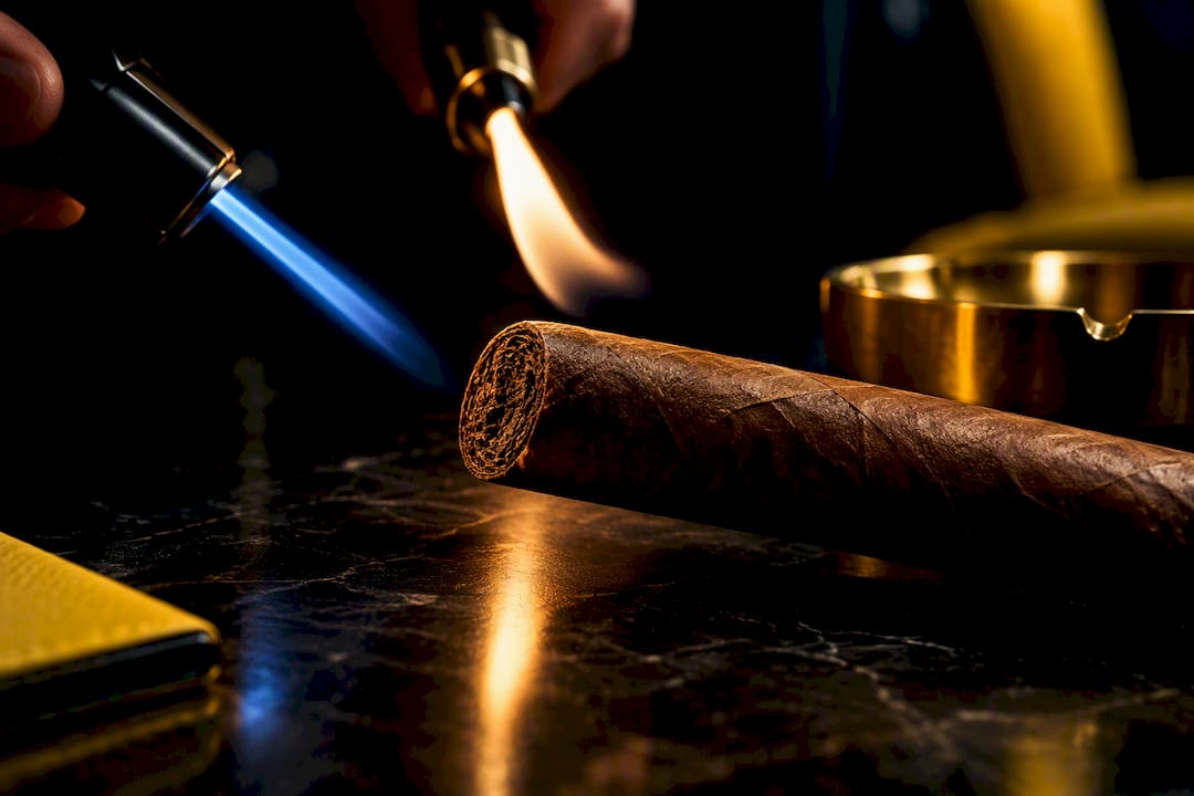 Torch and soft flames beside cigar foot
