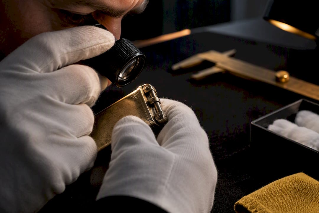 Appraiser inspecting a lighter hallmark