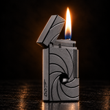 A metallic silver lighter with a textured spiral design and a lit flame, standing on a dark reflective surface against a black background. — view 3