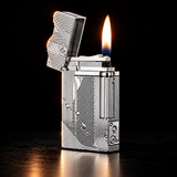 A silver metallic lighter with intricate geometric engravings and a lit flame, set against a dark black background. — view 2