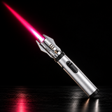 A silver lighter with red flame diagonally across a dark studio background — view 2